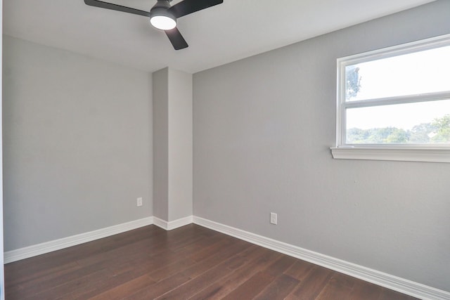 empty room with ceiling fan and dark hardwood / wood-style flooring