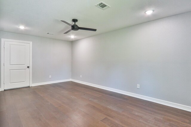 spare room with ceiling fan and dark wood-type flooring