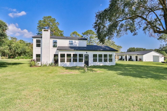 rear view of property with a yard