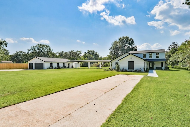 view of front of house featuring an outdoor structure, a front yard, and a garage