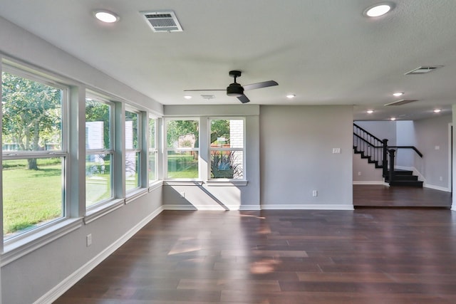 interior space with dark hardwood / wood-style flooring and ceiling fan