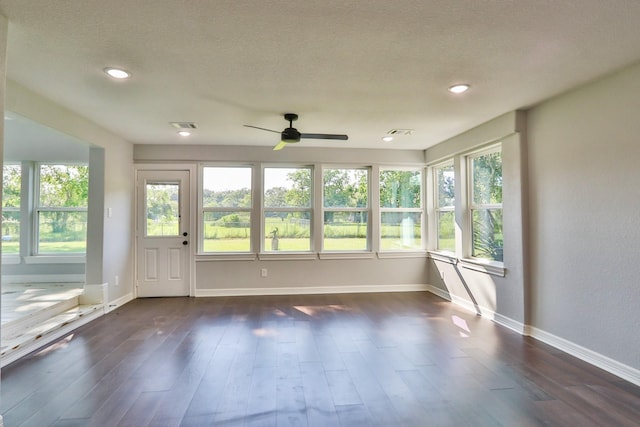 unfurnished sunroom with ceiling fan