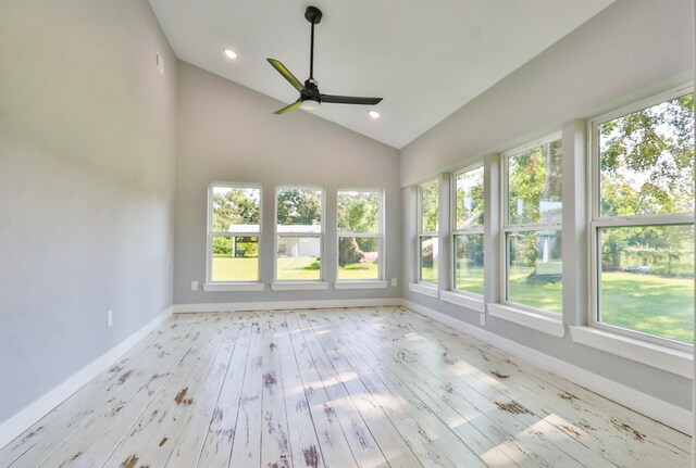 unfurnished sunroom with ceiling fan, a healthy amount of sunlight, and lofted ceiling