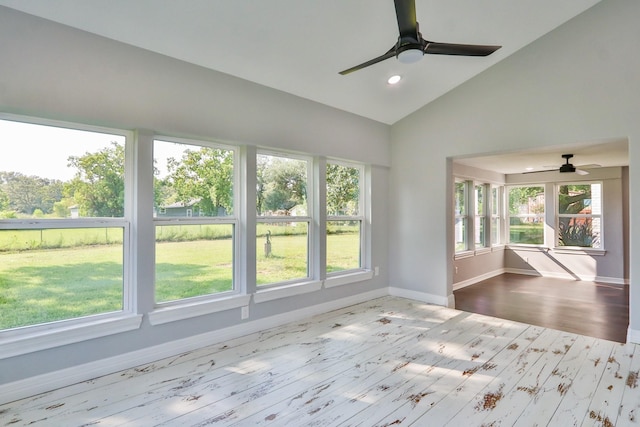 unfurnished sunroom featuring vaulted ceiling