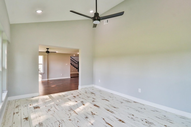 spare room with ceiling fan, high vaulted ceiling, and light hardwood / wood-style floors