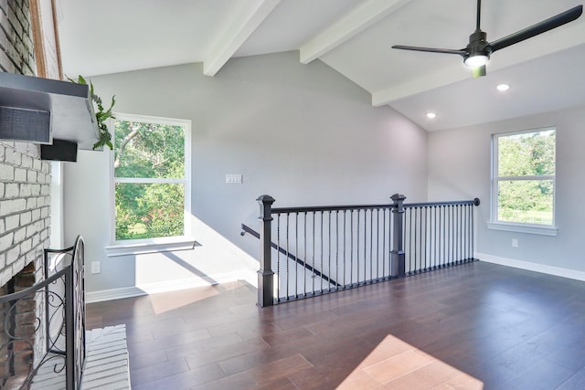 staircase with hardwood / wood-style floors, lofted ceiling with beams, ceiling fan, and a healthy amount of sunlight