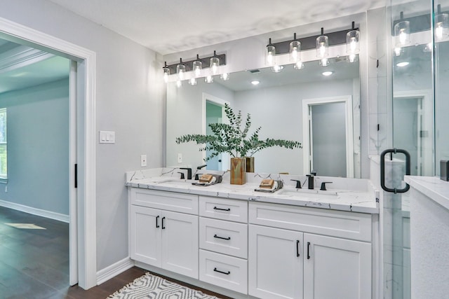 bathroom featuring wood-type flooring, vanity, and a shower with door