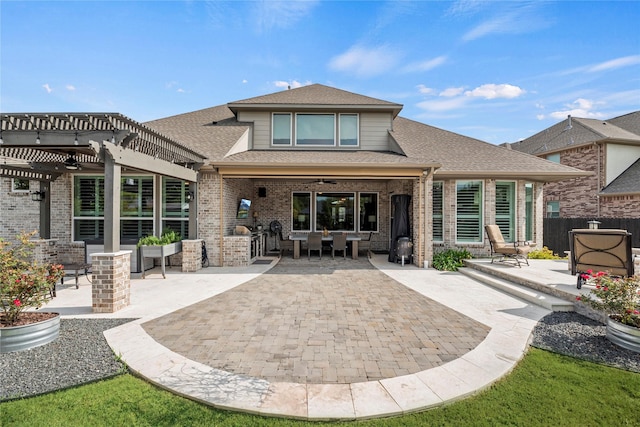 rear view of property with a patio, brick siding, fence, a ceiling fan, and a pergola