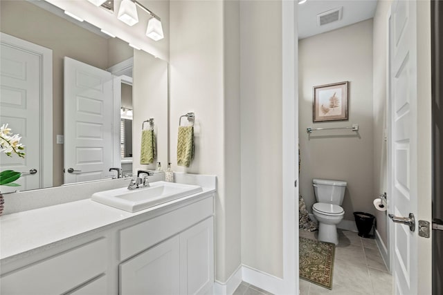 bathroom with tile patterned floors, vanity, and toilet