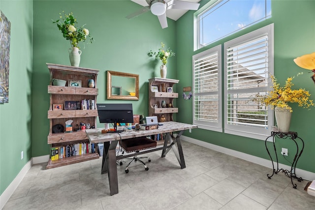 home office with ceiling fan and light tile patterned floors