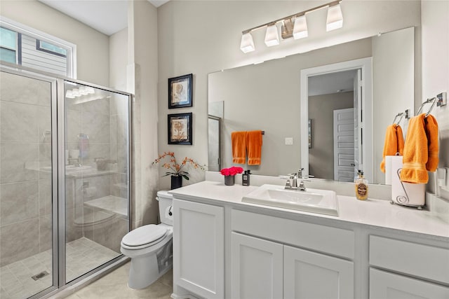 bathroom with tile patterned floors, vanity, toilet, and walk in shower