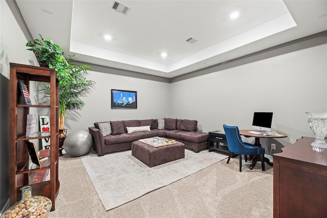 carpeted living room featuring a tray ceiling