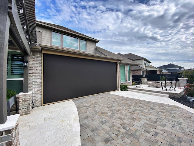 view of front of property featuring a fire pit and a patio area