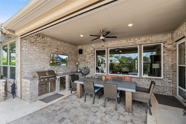 view of patio with an outdoor kitchen, grilling area, and ceiling fan