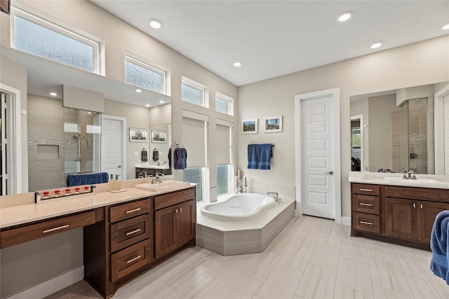 bathroom with vanity and separate shower and tub