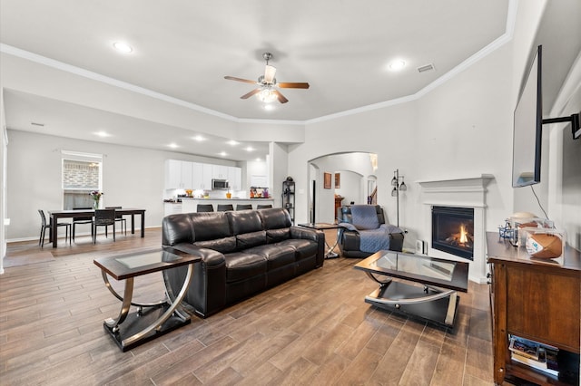 living room featuring ceiling fan and ornamental molding