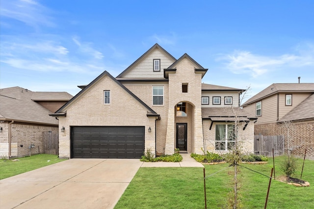 view of front of property with a front yard and a garage