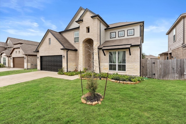 view of front of property with a garage and a front lawn