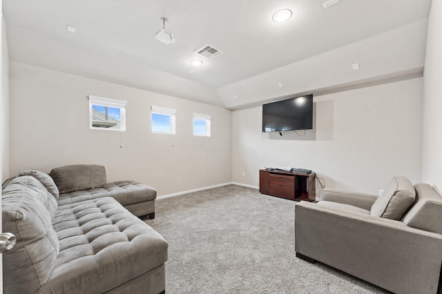 carpeted living room featuring vaulted ceiling