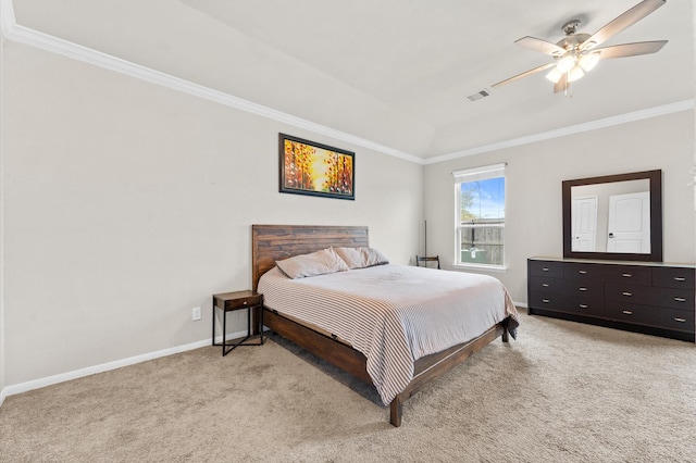 bedroom with a raised ceiling, ceiling fan, light colored carpet, and crown molding