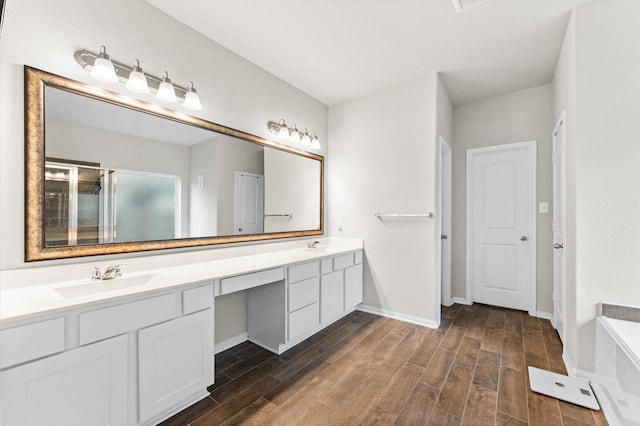 bathroom with vanity and shower with separate bathtub