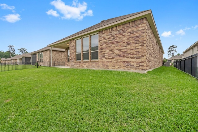 back of property featuring a lawn