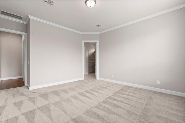 unfurnished room with ornamental molding and light carpet