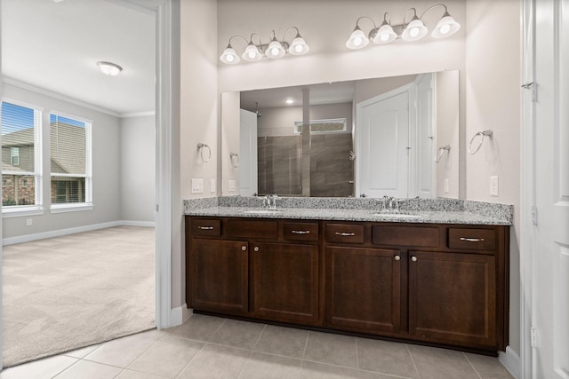 bathroom with tile patterned floors, vanity, an enclosed shower, and ornamental molding