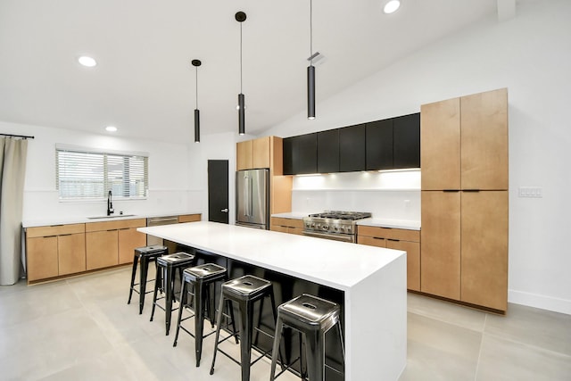 kitchen featuring a kitchen bar, premium appliances, sink, pendant lighting, and a kitchen island