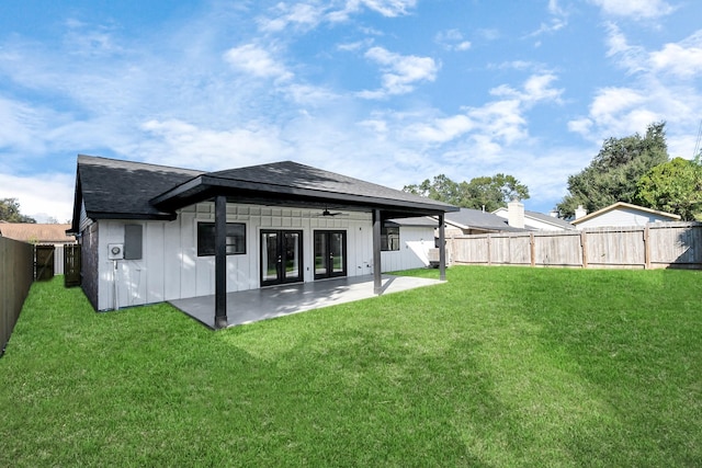 back of property featuring ceiling fan, a yard, and a patio