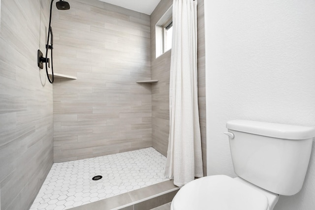 bathroom featuring curtained shower and toilet