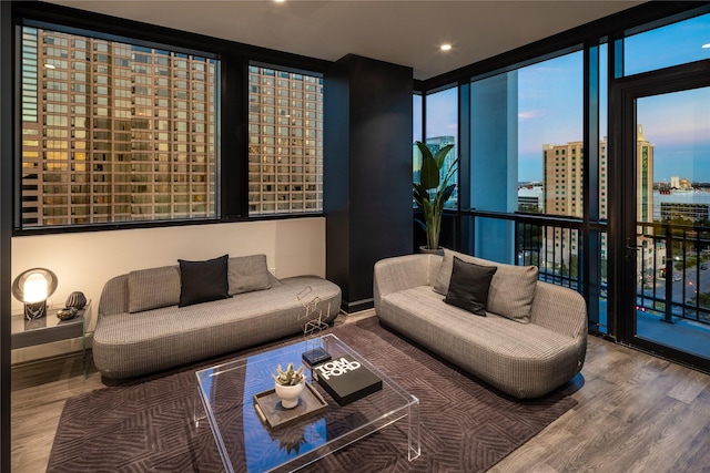 living room with wood-type flooring and a wall of windows