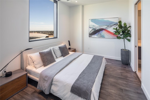 bedroom with dark hardwood / wood-style floors