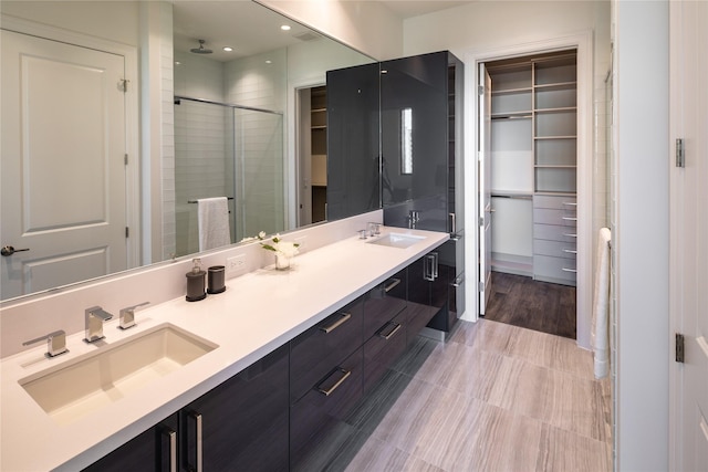 bathroom with vanity and a shower with shower door