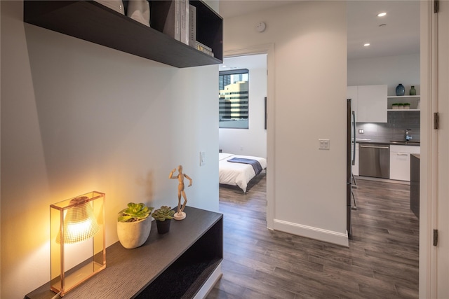 hall featuring dark hardwood / wood-style flooring and sink