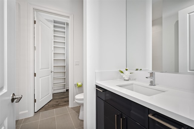 bathroom with tile patterned floors, vanity, and toilet