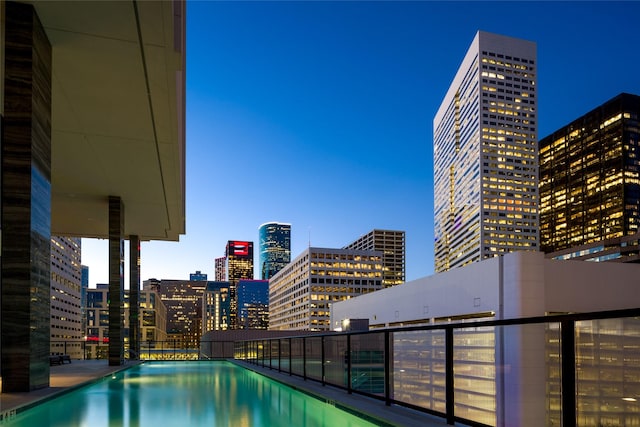 view of pool at dusk