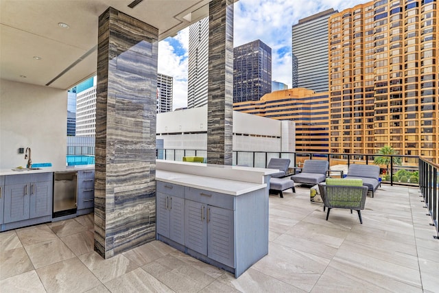 view of patio / terrace with an outdoor hangout area and sink