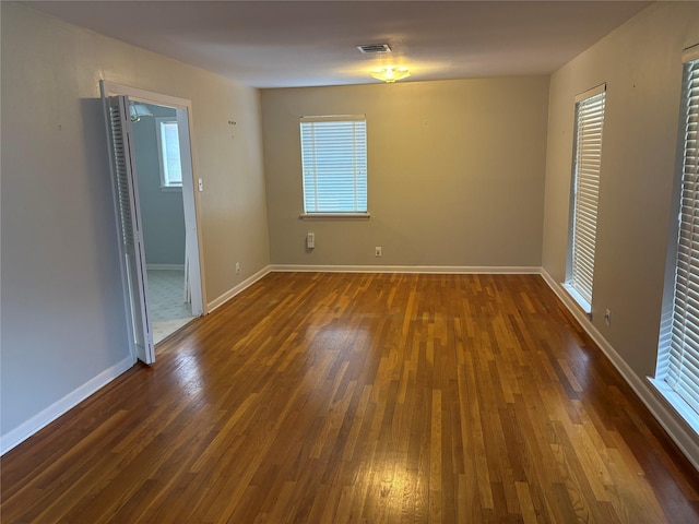 spare room with dark hardwood / wood-style floors