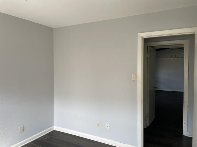 unfurnished room featuring dark wood-type flooring