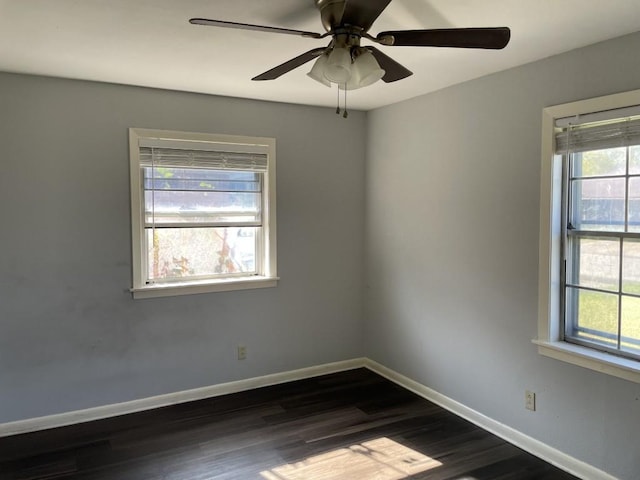 spare room featuring dark hardwood / wood-style floors and ceiling fan