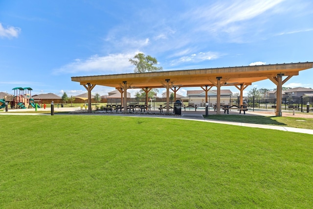 view of community featuring a playground and a yard