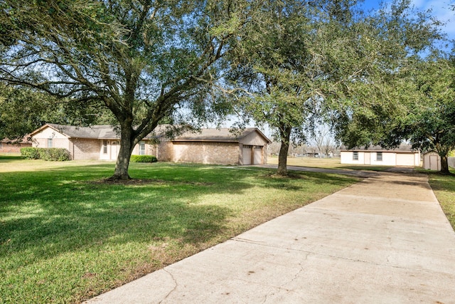 ranch-style house featuring a front yard and a garage