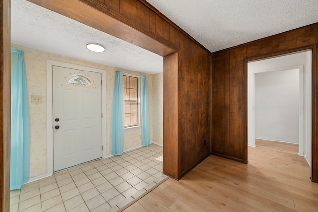 entryway featuring a textured ceiling and light hardwood / wood-style flooring