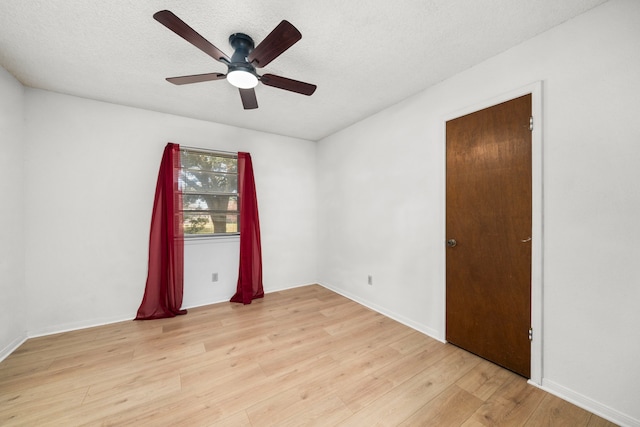 unfurnished room featuring ceiling fan, a textured ceiling, and light hardwood / wood-style flooring