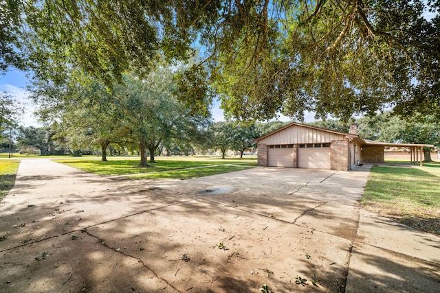 exterior space with a garage and a yard