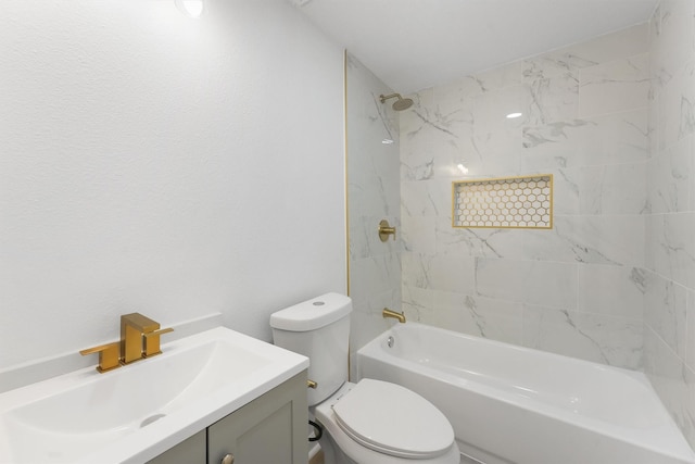 full bathroom featuring toilet, vanity, and tiled shower / bath