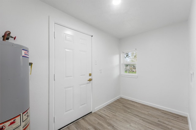 interior space with gas water heater and light hardwood / wood-style flooring