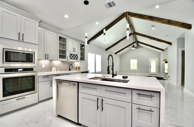 kitchen featuring ceiling fan, sink, backsplash, decorative light fixtures, and appliances with stainless steel finishes