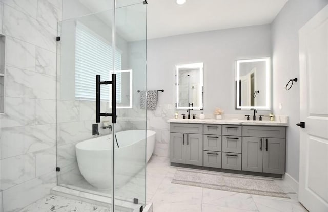 bathroom with vanity, shower with separate bathtub, and tile walls